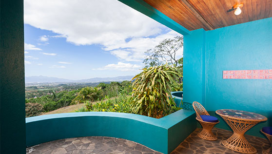 Rainforest valley and blue sky view from villa room balcony